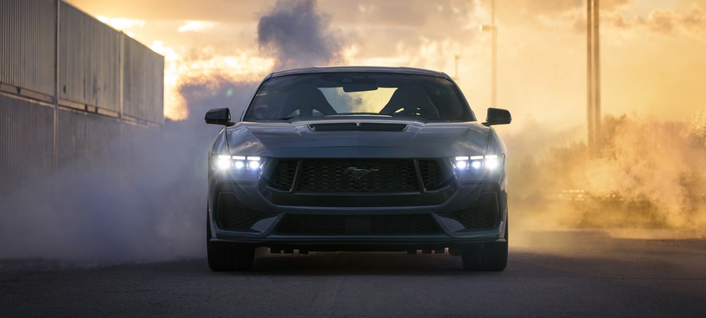Fleet of Ford Mustang Cars driving on track