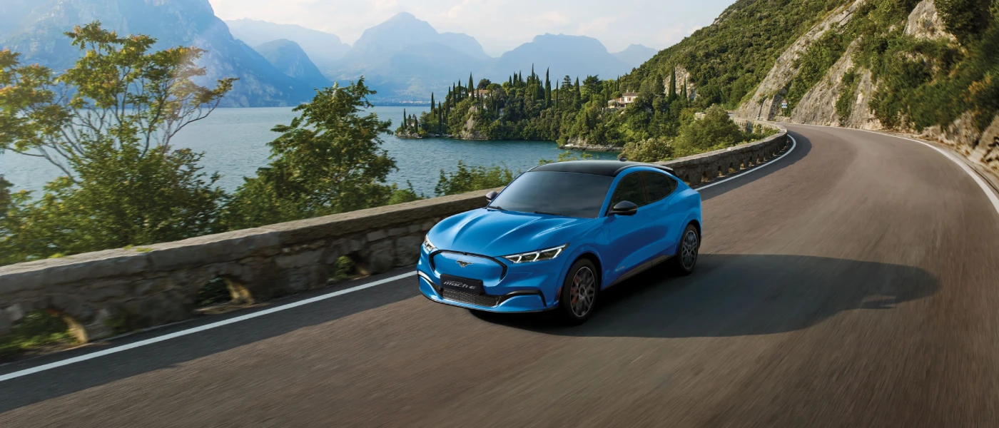 front view of blue car with lake beside